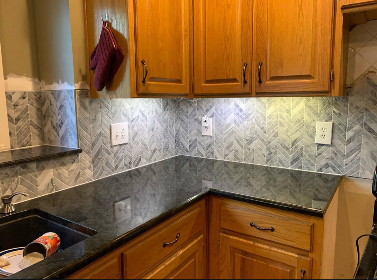 Kitchen with herringbone tile backsplash